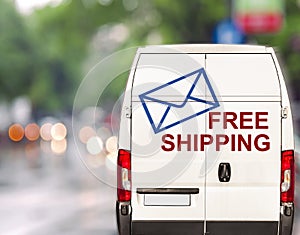 White free shipping Van driving fast on city blurr bokeh street photo