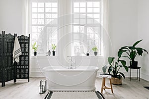 White freestanding bathtub in light luxury bathroom