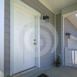 White front door of a home with porch and garage