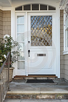 White front door of upscale beige home