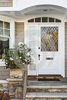 White front door of upscale beige home