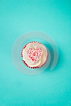 White Frosting Cupcake Topped with Candy Heart Overhead for Vale