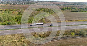 White fuel truck drives on the highway, fuel truck moves on the highway in sunny weather