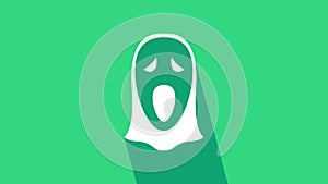 White Funny and scary ghost mask for Halloween icon isolated on green background. Happy Halloween party. 4K Video motion