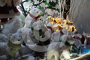 White furry animatronics of polar bears, penguins and arctic ferrets in a fake snowy city background