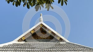 White gable of a public hall in rural area on blue sky