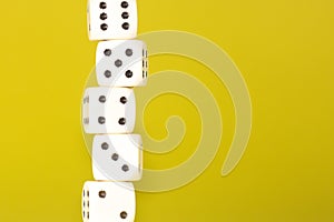 White gaming dices on yellow background. Victory chance and lucky. Place for text. Top view and Close-up cube. Concept business,