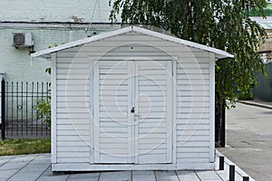 White garage with closed doors.