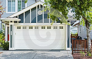 White Garage door with driveway. Residencial garage door. Garage door in luxury house. Real Estate Exterior Front house