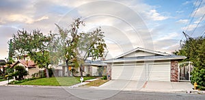 White garage in front of house and tree in Encino, CA