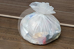 white garbage bag put on room floor, waiting to be moved out