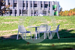 White garden table and chairs on a patio patio outside of an office building