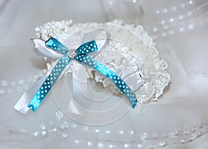 White garter with blue ribbon and diamante photo