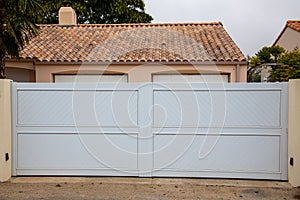 White gate large portal with panel blades in city suburbs house street