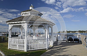 White gazebo by a harbor in the early morning