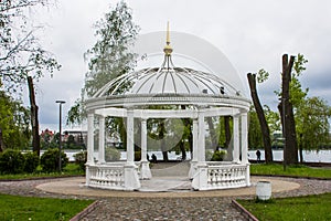 White gazebo on an island in the middle of a lake in Ternopil. Ukraine