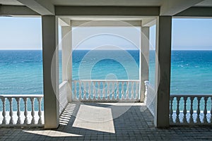 White gazebo on the waterfront with seascape view