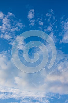 White gentle clouds in blue sky, vertical format_