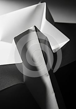 White geometric paper shapes with sharp, angular lines create a dynamic composition