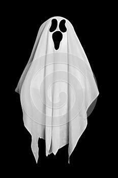 White ghost from the blanket on black background. Halloween decoration.