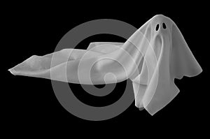 White ghost sheet costume rise up from the floor with black background. Minimal Halloween scary concept