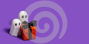 White Ghosts Halloween decor and small gift box on a purple background