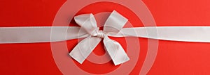 White gift bow on red