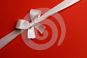 White gift bow on red