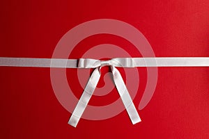 White gift bow on red