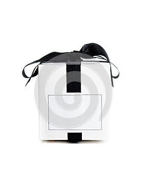 White gift box with empty lable and black satin ribbon isolated on white background, stylish holiday present