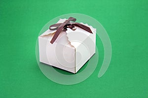 White gift box on a green background