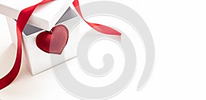 White gift box open, red heart and satin ribbon on white, space. Valentine day present