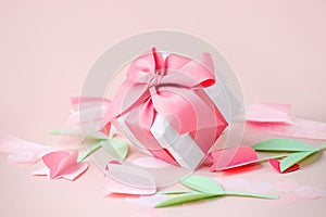White gift box on pink background, decorated with textured bow, creating romantic luxury atmosphere. For birthday, Easter,
