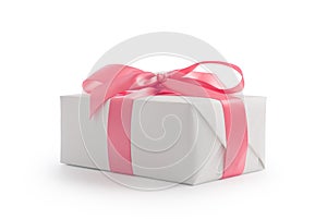 White gift box with pink ribbon bow isolated on white background