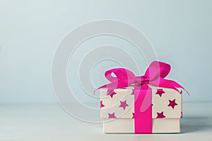 White gift box with pink star pattern and pink ribbon bow
