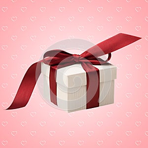 White gift box with red bow