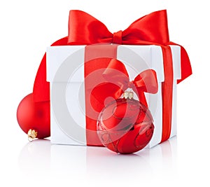 White gift box tied red ribbon and Christmas balls Isolated