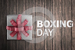 White gift box wrapped with red ribbon with Boxing Day sign