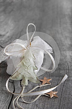 White gift for christmas on a grey shabby chic background with a