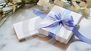 White Gift Wrapping With Blue Flowers On Marble Surface