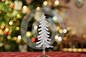 White glass christmas tree object in front of blurred background