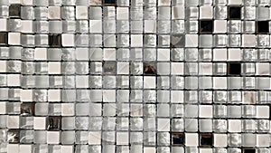 White glass mosaic in the bathroom. Light ceramic checkered wall and mosaic background in the kitchen. Geometric design pattern