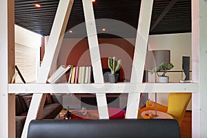 white glazed wooden beams, half-timbered optics as modern room dividers with books