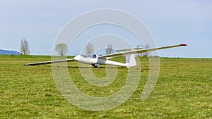 White glider on the grass airfield