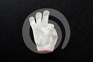 White glove with gesture of OK on black