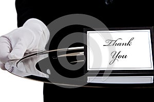 White gloved hand holding a silver tray