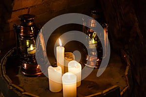 White glowing lanterns with delicate design on table in a garden.