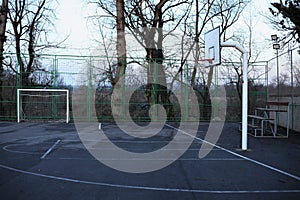 White goal and basket, bench for spectators