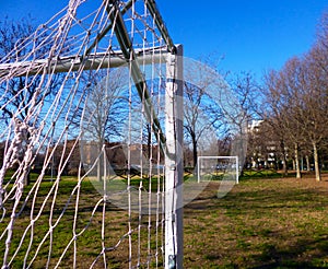 White goal post in a little soccer field outdoor in a city park. photo