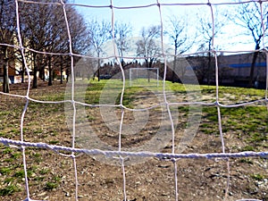 White goal post in a little soccer field outdoor in a city park. photo